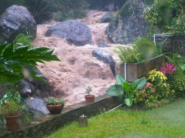 A river in St. Andrew rises with the falling rain